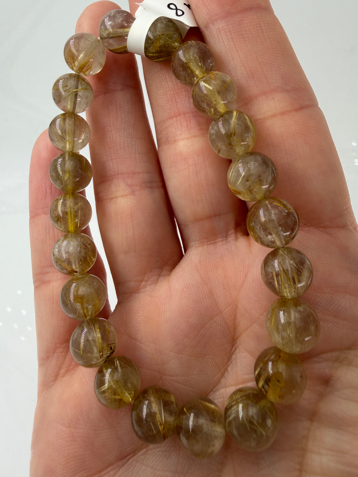 Kugelarmband aus klarem Rutilquarz mit dichten, goldfarbenen Rutilnadeln.